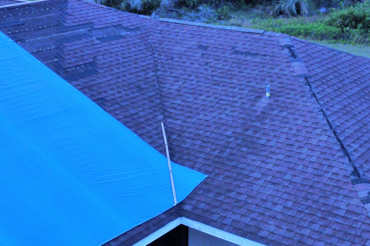 Wind damage on roof requiring insurance claim assistance